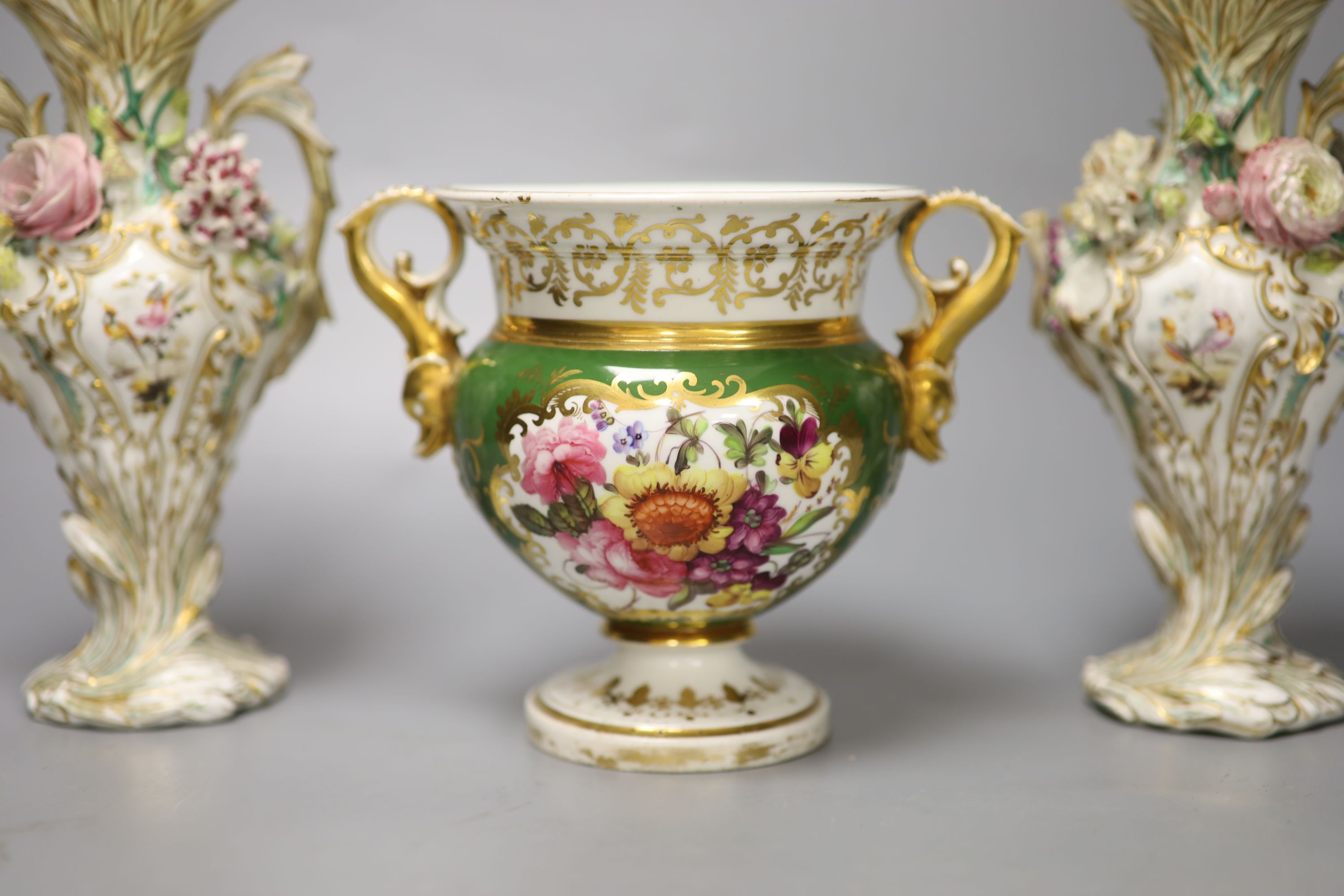 An English porcelain two handled green ground vase and a pair of floral encrusted vases, 20cm